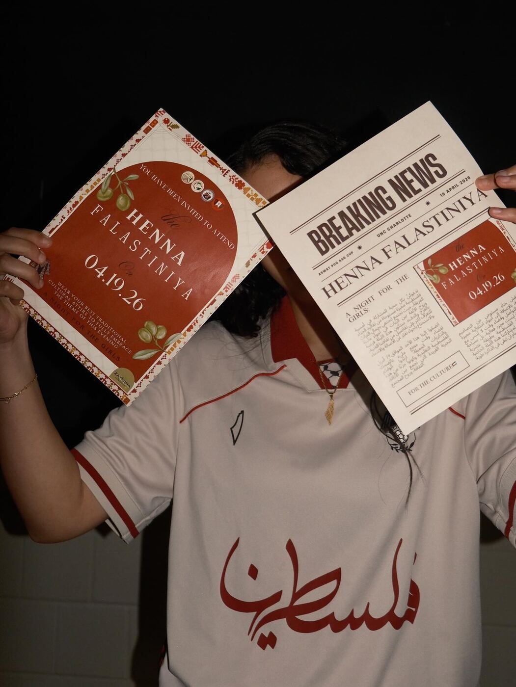 Member holding the Henna Falastiniya invite and a Breaking News flyer